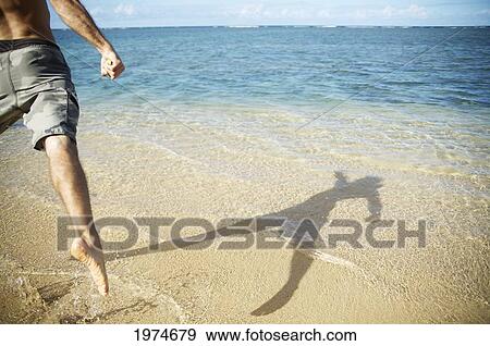 Stock Photo - Hawaii, Kauai, Anini Beach, Shadow Of A Person In The Water.. Fotosearch