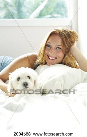 Hawaii, Kauai, Attractive Young Redheaded Woman Models In Bed With Her Puppy. View Large Photo Image Stock Photo - Hawaii, Kauai, Attractive Young Redheaded Woman Models In Bed With Her Puppy.. Fotosearch