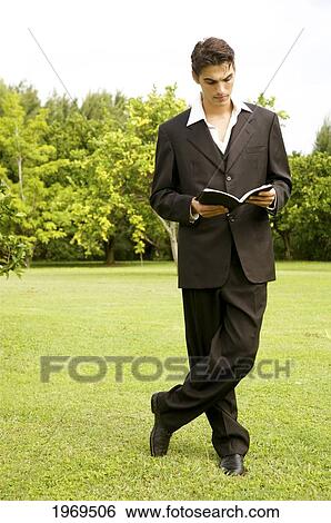 Hawaii, Kauai, Business Man Reading A Book On A Grassy Field View Large Photo Image Stock Photograph - Hawaii, Kauai, Business Man Reading A Book On A Grassy Field. Fotosearch