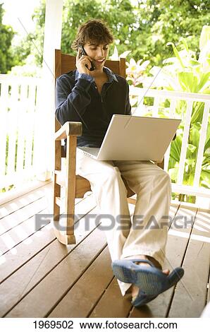 Stock Image - Hawaii, Kauai, Business Man Talking On Cell Phone.. Fotosearch