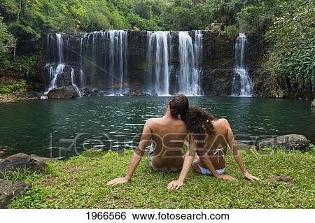 Hawaii, Kauai, Couple Sitting Together At Kilauea Falls. View Large Photo Image Stock Photograph - Hawaii, Kauai, Couple Sitting Together At Kilauea Falls.. Fotosearch