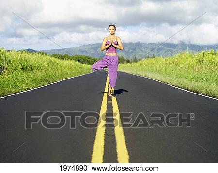 Hawaii, Kauai, East Side, Woman Doing Yoga On The Road. View Large Photo Image Stock Image - Hawaii, Kauai, East Side, Woman Doing Yoga On The Road.. Fotosearch