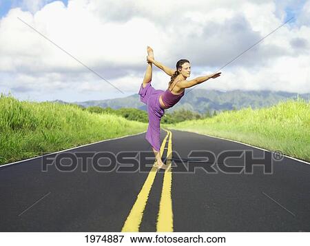 Hawaii, Kauai, East Side, Woman Doing Yoga On The Road. View Large Photo Image Stock Photo - Hawaii, Kauai, East Side, Woman Doing Yoga On The Road.. Fotosearch