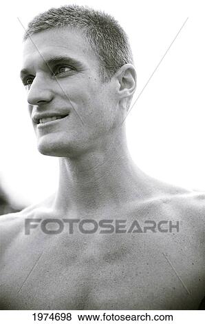 Stock Photo - Hawaii, Kauai, Fit Male Posing On Rocky Coastline.. Fotosearch