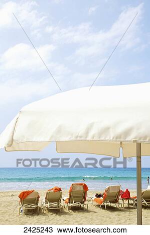 Stock Image - Hawaii, Kauai, furniture on the beach at a resort.. Fotosearch