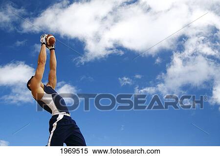 Hawaii, Kauai, Haena Beach, Fit Male Holding A Football With Beautiful Clouds In The Background. View Large Photo Image Stock Photography - Hawaii, Kauai, Haena Beach, Fit Male Holding A Football With Beautiful Clouds In The Background.. Fotosearch