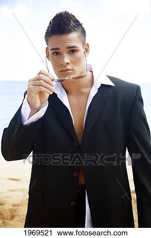Stock Image - Hawaii, Kauai, Haena Beach, Portrait Of A Young Model In Business Attire.. Fotosearch