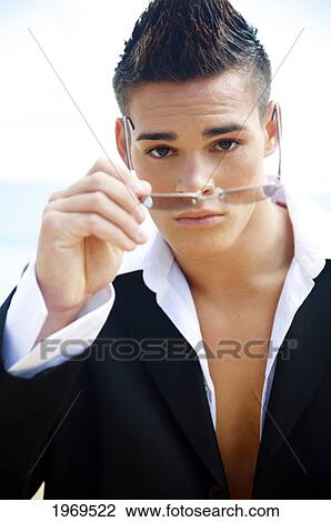 Stock Image - Hawaii, Kauai, Haena Beach, Portrait Of A Young Model In Business Attire.. Fotosearch