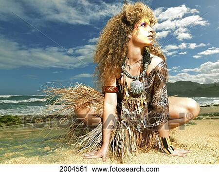 Stock Image - Hawaii, Kauai, Haena, Model Poses With Polynesian Tribal Fashions.. Fotosearch