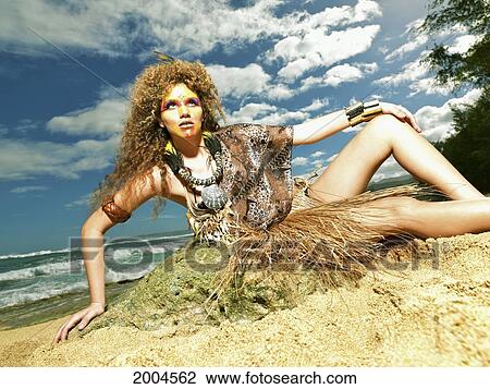 Stock Image - Hawaii, Kauai, Haena, Model Poses With Polynesian Tribal Fashions.. Fotosearch