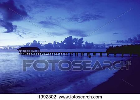 Stock Image - Hawaii, Kauai, Hanalei Bay, Pier At Twilight, Deep Blue Sky And Ocean.. Fotosearch