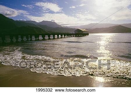 Stock Image - Hawaii, Kauai, Hanalei Bay, Sandy Shore And Pier. Fotosearch