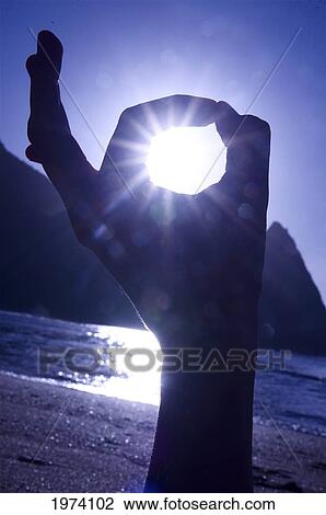 Stock Image - Hawaii, Kauai, Hanalei Bay, Sunset With Beautiful Reflections With Silhouette Of Hand In Foreground.. Fotosearch