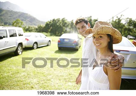 Stock Photo - Hawaii, Kauai, Hanalei Bay, Waipa's Farmers Market, Young Couple Swalking To Their Car At The Local Farmers Market.. Fotosearch