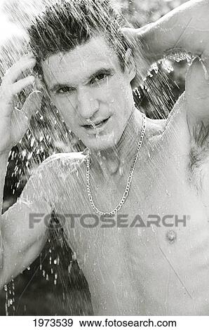 Hawaii, Kauai, Hanalei Bay, Young Man At The Beach Showering After A Day Of Surfing. View Large Photo Image Stock Photo - Hawaii, Kauai, Hanalei Bay, Young Man At The Beach Showering After A Day Of Surfing.. Fotosearch