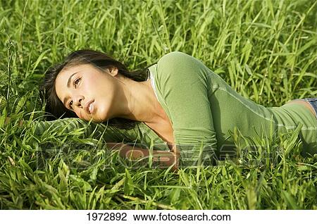 Stock Image - Hawaii, Kauai, Hanalei, Beautiful Fashion Model 0N A Grassy Field.. Fotosearch