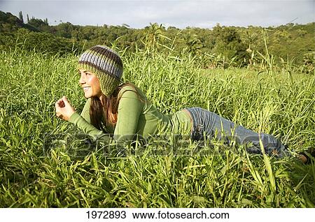 Stock Image - Hawaii, Kauai, Hanalei, Beautiful Fashion Model 0N A Grassy Field.. Fotosearch