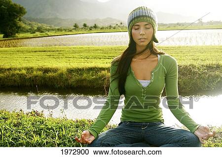 Stock Image - Hawaii, Kauai, Hanalei, Beautiful Fashion Model 0N A Grassy Field.. Fotosearch