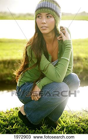 Stock Image - Hawaii, Kauai, Hanalei, Beautiful Fashion Model 0N A Grassy Field.. Fotosearch