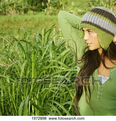 Stock Photo - Hawaii, Kauai, Hanalei, Beautiful Fashion Model 0N A Grassy Field.. Fotosearch