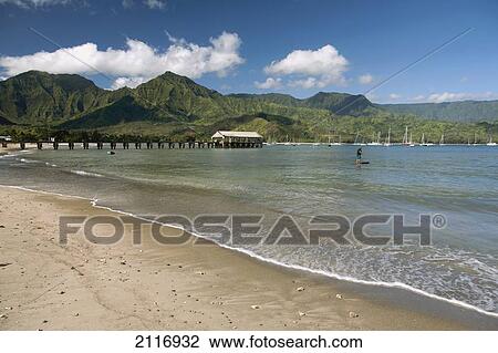 Stock Image - Hawaii, Kauai, Hanalei, Hanalei Bay and Pier from beach.. Fotosearch