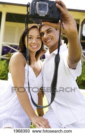 Stock Image - Hawaii, Kauai, Hanalei, Young Couple Posing For The Camera.. Fotosearch
