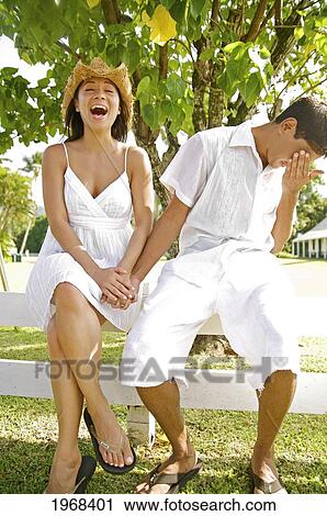 Stock Image - Hawaii, Kauai, Hanalei, Young Couple Having A Laughing Moment.. Fotosearch