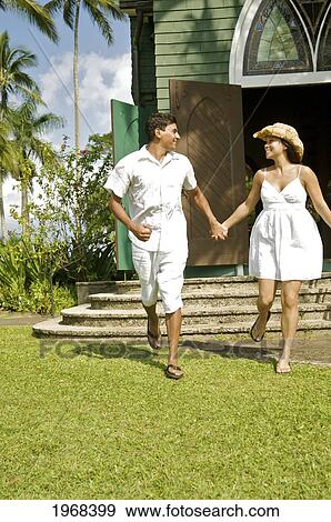 Stock Photo - Hawaii, Kauai, Hanalei, Young Married Couple Running Out Of The Church.. Fotosearch