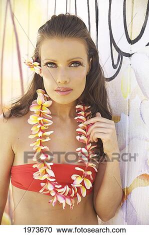 Stock Image - Hawaii, Kauai, Kapaa, Beautiful Woman Dancing Hula On A Beautiful Painted Backdrop Of A Beach.. Fotosearch
