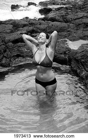 Hawaii, Kauai, Kauapea Beach (Secret Beach) Beautiful Woman In The Water, Black And White. View Large Photo Image Stock Image - Hawaii, Kauai, Kauapea Beach (Secret Beach) Beautiful Woman In The Water, Black And White.. Fotosearch