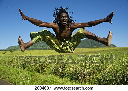 Hawaii, Kauai, Kealia, African Dancer Leaping Into The Air Along Grassy Roadside. View Large Photo Image Stock Photo - Hawaii, Kauai, Kealia, African Dancer Leaping Into The Air Along Grassy Roadside.. Fotosearch