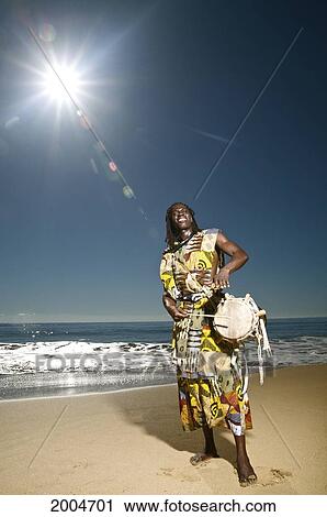 Hawaii, Kauai, Kealia Beach, African Dancer On Shore With Drum. View Large Photo Image Stock Image - Hawaii, Kauai, Kealia Beach, African Dancer On Shore With Drum.. Fotosearch