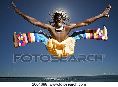 Hawaii, Kauai, Kealia Beach, African Dancer Leaping Above Ocean Horizon On Shore. View Large Photo Image Stock Photo - Hawaii, Kauai, Kealia Beach, African Dancer Leaping Above Ocean Horizon On Shore.. Fotosearch