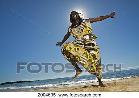 Stock Photography - Hawaii, Kauai, Kealia Beach, African Dancer On Sandy Shore.. Fotosearch
