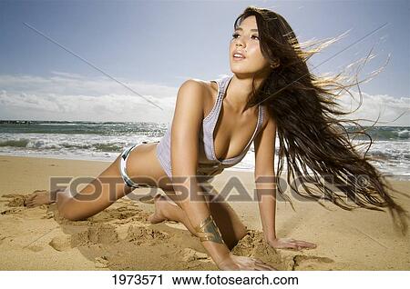 Stock Image - Hawaii, Kauai, Kealia Beach, Attractive Young Woman On The Beach.. Fotosearch