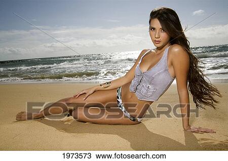 Stock Image - Hawaii, Kauai, Kealia Beach, Attractive Young Woman On The Beach.. Fotosearch
