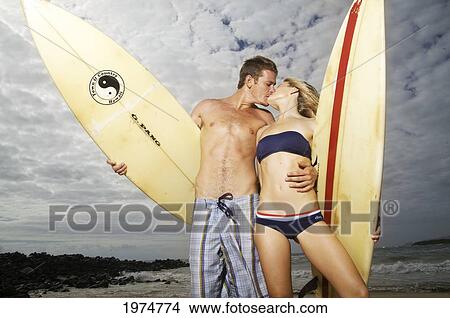 Picture - Hawaii, Kauai, Kealia Beach, Beautiful Surfer Couple On The Beach.. Fotosearch