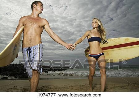 Hawaii, Kauai, Kealia Beach, Beautiful Surfer Couple On The Beach. View Large Photo Image Stock Photo - Hawaii, Kauai, Kealia Beach, Beautiful Surfer Couple On The Beach.. Fotosearch