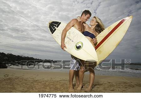 Hawaii, Kauai, Kealia Beach, Beautiful Surfer Couple On The Beach. View Large Photo Image Stock Photography - Hawaii, Kauai, Kealia Beach, Beautiful Surfer Couple On The Beach.. Fotosearch