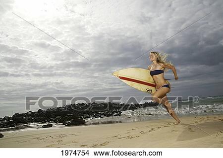 Picture - Hawaii, Kauai, Kealia Beach, Surfer Girl Enjoying A Day Out.. Fotosearch
