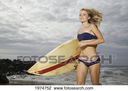 Stock Image - Hawaii, Kauai, Kealia Beach, Surfer Girl Enjoying A Day Out.. Fotosearch