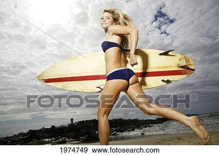 Stock Photo - Hawaii, Kauai, Kealia Beach, Surfer Girl Enjoying A Day Out.. Fotosearch