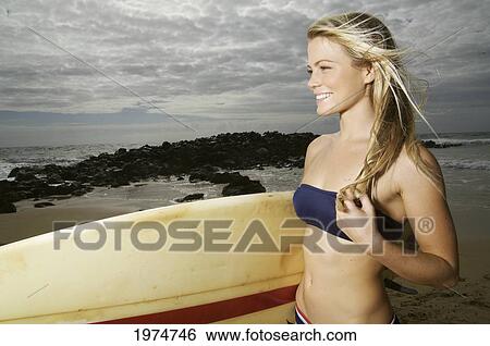 Stock Photograph - Hawaii, Kauai, Kealia Beach, Surfer Girl Enjoying A Day Out.. Fotosearch