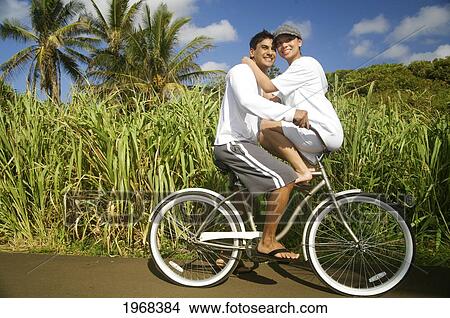 Hawaii, Kauai, Kealia Beach, Young Couple On A Bike Path, Overexposed. View Large Photo Image Picture - Hawaii, Kauai, Kealia Beach, Young Couple On A Bike Path, Overexposed.. Fotosearch