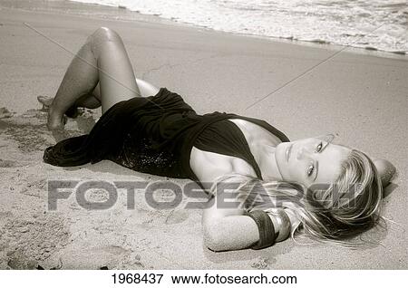 Stock Photo - Hawaii, Kauai, Kealia, Beautiful Fashion Model On Beach Wearing A Dress, Black And White.. Fotosearch