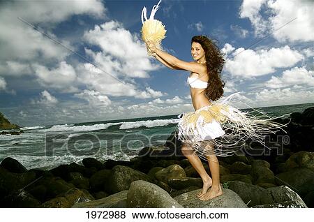 Stock Photo - Hawaii, Kauai, Kealia, Beautiful Hawaiian Girl Dancing Hula On Ocean Shoreline.. Fotosearch