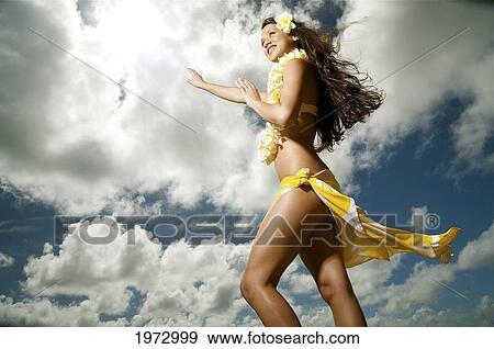 Stock Photo - Hawaii, Kauai, Kealia, Beautiful Hawaiian Girl Dancing Hula On Ocean Shoreline.. Fotosearch