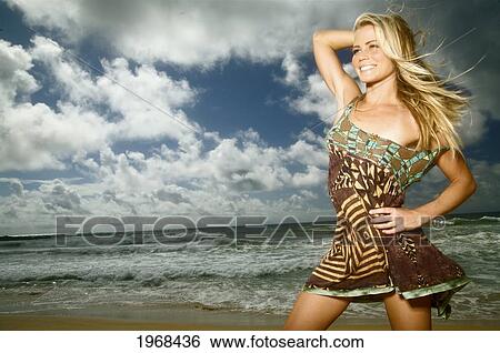 Stock Photograph - Hawaii, Kauai, Kealia, Beautiful Fashion Model On Beach Wearing A Dress.. Fotosearch