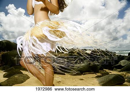 Stock Photograph - Hawaii, Kauai, Kealia, Beautiful Hawaiian Girl Dancing Hula On Ocean Shoreline.. Fotosearch
