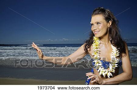 Picture - Hawaii, Kauai, Kealia, Beautiful Woman Dancing Hula On Ocean Shoreline.. Fotosearch